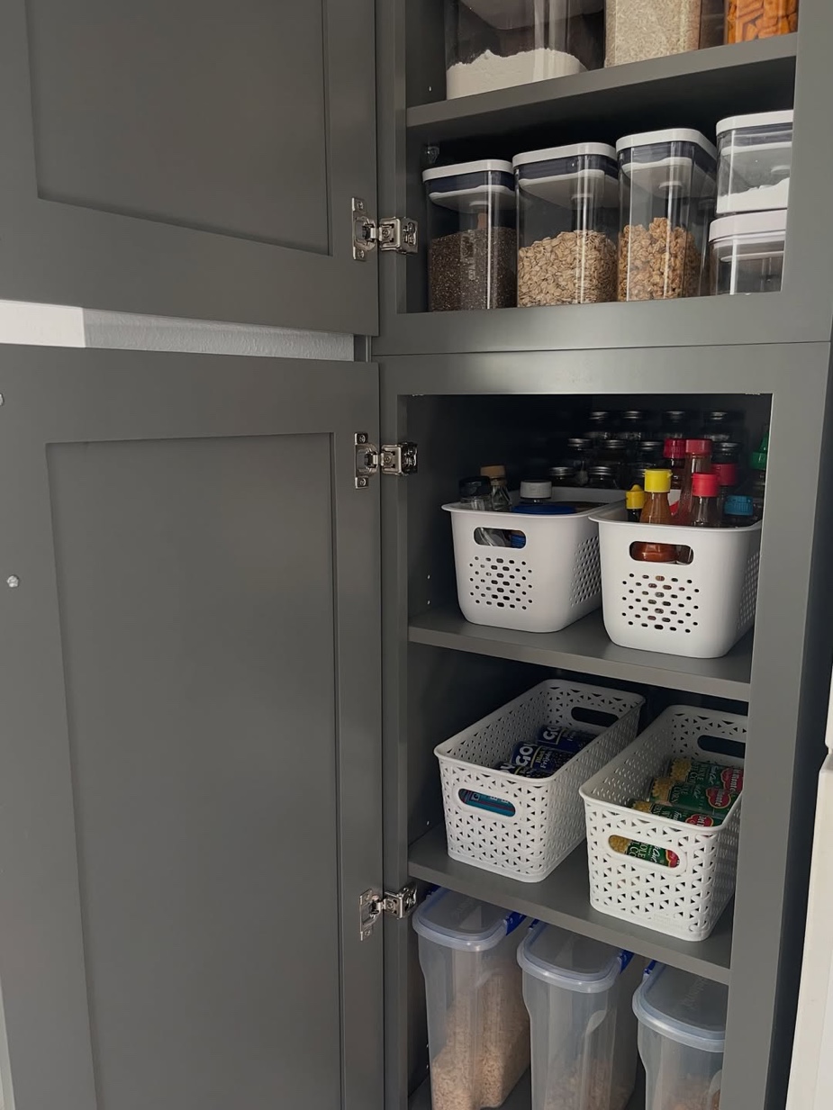 Gray cabinet pantry with perforated bins and airtight containers, Lattingtown Long Island