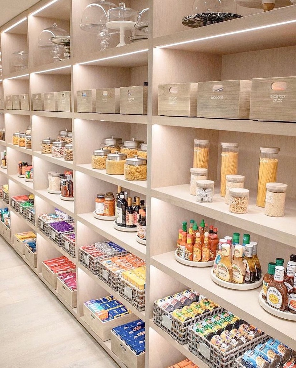 Grand open pantry with integrated LED lighting, lazy susan turntables, labeled wooden bins, and clear containers, Old Westbury Long Island